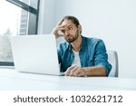 Work Stress. Man Working On Computer. Male Worker Feeling Stressed And Exhaused. Tired Man In Casual Clothes Sitting At Workplace With Laptop In Modern Office. Failure And Hard Work. High Quality