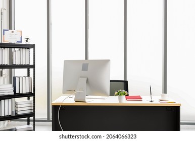 The work table is located in the office room. There were computers and red notebooks on the table. There is a bookshelf in the room. Executive or manager's desks
It is a desk that looks classy 