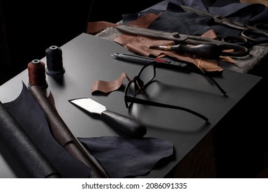 Work table with the tool of a craftsman for the manufacture of leather goods. - Powered by Shutterstock