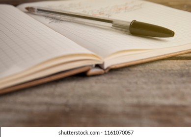 Work and time management, opened notebook over rustic, old textured wooden table. Copy space.