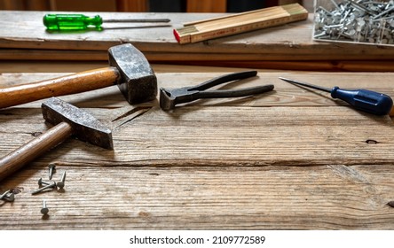 Work Tool Old Used, Hammer, Sledgehammer Plincers And Nail On Wood, Carpenter Workshop Bench Table, Closeup View