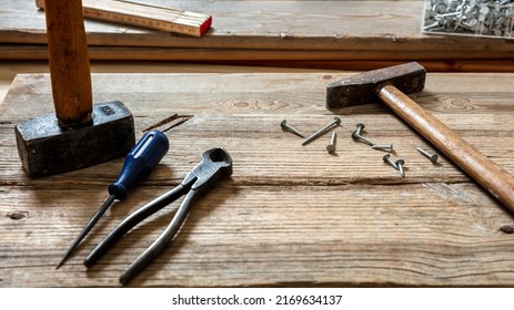 Work Tool Old Used, Hammer, Sledgehammer Plincers And Nail On Wood, Carpenter Workshop Bench Table, Closeup View