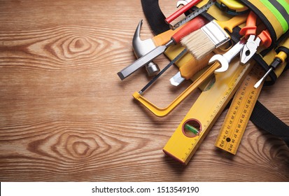 Work tools on wooden background.