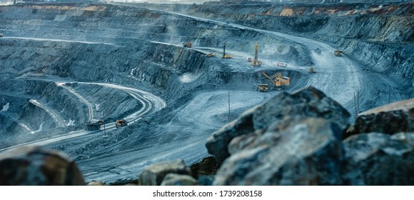 Work of trucks and the excavator in an open pit on gold mining, soft focus - Shutterstock ID 1739208158