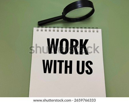 Work With Us Written on Notebook with Magnifying Glass – Concept of Recruitment, Team Collaboration, Job Opportunity, and Company Hiring Campaign. 