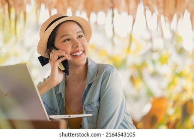 work and vacation asian female digital nomad millennial lifestyle hand hold smartphone conversation with abroad client distance meeting,asian female casual cloth walking speaking on the beach ocean - Powered by Shutterstock