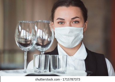 Work Of A Waiter In A Restaurant In A Medical Mask