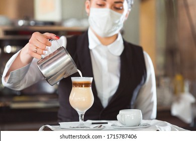 Work Of A Waiter In A Restaurant In A Medical Mask