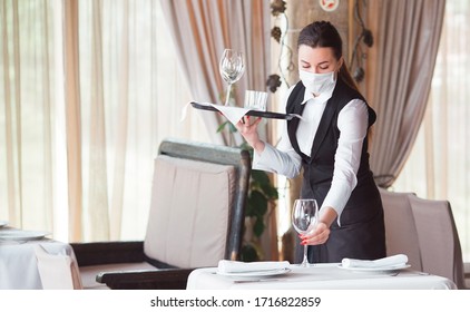 Work Of A Waiter In A Restaurant In A Medical Mask