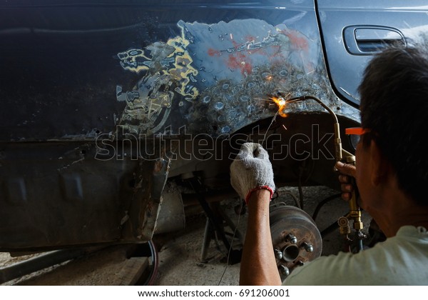 Work with\
welding equipment - welding car body,Worker repairing car body, Car\
body worker welding car body\
blur.