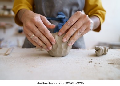 Work with your hands: closeup of creative woman molding raw clay before sculpturing and shaping pottery or ceramics in potter art studio during master class or workshop. Craft and craftswoman concept - Powered by Shutterstock