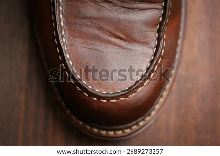 Workboot toe box with well defined stitches and leather