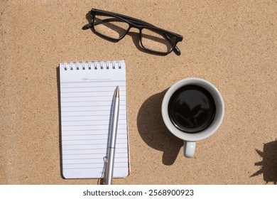 Workday Essentials: Empty Note, Eyeglasses, Pen, and Coffee Mug, Top View
