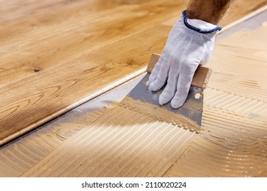 Worker Apply Adhesive For 3 Layer Parquet Flooring