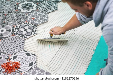 Worker Applying Tile Adhesive On The Floor