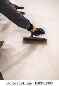 Worker Applying A White Epoxy Resin Bucket On Floor
