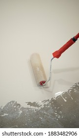 Worker Applying A White Epoxy Resin Bucket On Floor
