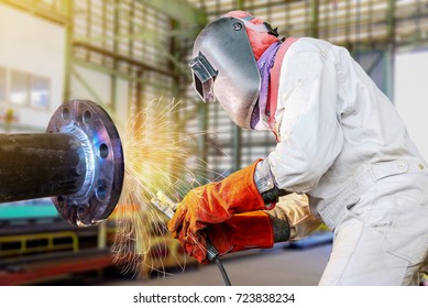 worker arc welder steel piping welding in factor
