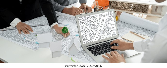 Worker, architect and engineer work on real estate construction project oratory planning with cartography and cadastral map of urban town area to guide to construction developer business plan of city