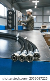 Worker assembles high pressure hose. High pressure hose production. Workplace. Factory.