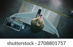Worker Assembling Drones For National Security. Adult Man in Camouflage Engaged in Specialized Assembly of Large, High tech Drone on Metal Workbench. Future of National Security Production. Top View.