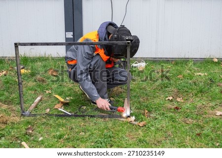 Worker assembling electronics with soldering iron and flux