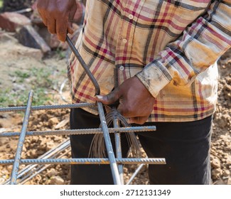 Worker Assembling Rebar Frame Using Binding Wire