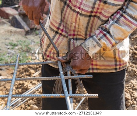 Worker Assembling Rebar Frame Using Binding Wire