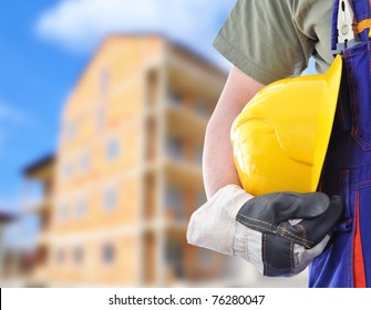 Worker And The Blurred Construction In Background