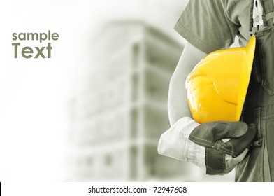 Worker And The Blurred Construction In Background With Space For Your Text