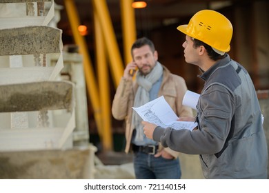 Worker And Boss Using Smart Phone Outside Factory