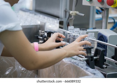 Worker in bottle plastic making working by hand in production line, factory, production,packing, process concept