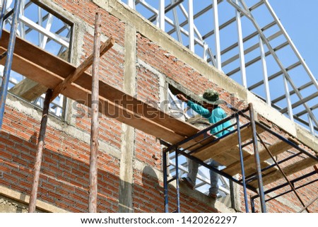 worker with brickwork in construction site