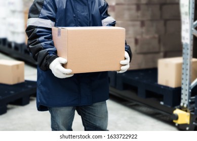 Worker carrying a goods box in a large frozen warehouse.Export-Import Logistics system concept. - Powered by Shutterstock