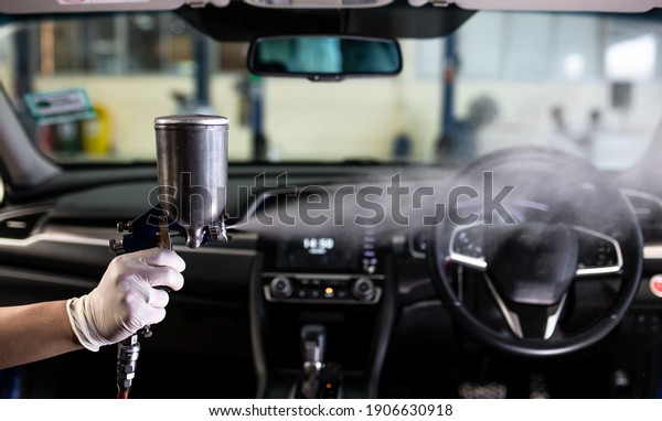 worker character in protective and suit sprays\
bacterial or virus in a\
car.