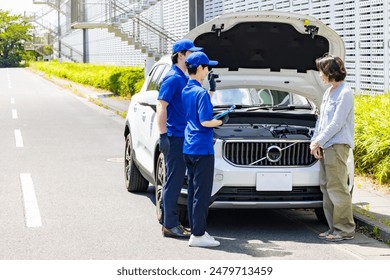Worker checking the engine compartment of a car. Automobile mechanic.