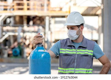 The Worker Is Checking To The Industrial Compressed Gas Cylinder In The Factory. A Gas Cylinder Is A Pressure Vessel For Storage And Containment Of Gases At Above Atmospheric Pressure.