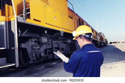 Worker Checking On Train Machine