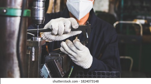 The worker is checking the quality size and design of the metal parts with Vernier Caliper from the metalwork in the factory. The manufacturing metal parts and the checking of quality. - Powered by Shutterstock - Get 15% off with code: PIKWIZARD15