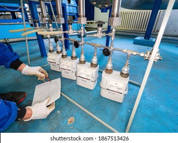 Worker Checks Methane Gas Consumption On Gas Flow Meters. Industrial Gas Meter And Consumption Meter. 3rd Of October 2020. Krakow, Poland.