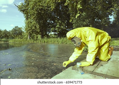 Worker In Chemical Protective Suit Collecting Samples Of Water Contamination