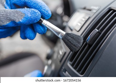 Worker Cleaning Automobile Air Conditioner Vent Grill With Brush, Closeup. Car Wash Service