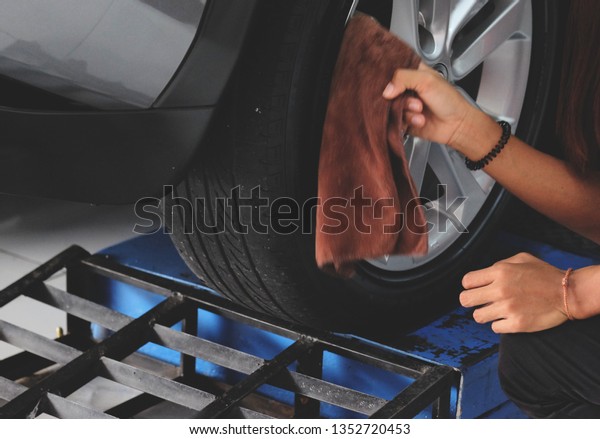 Worker cleaning car with\
clothes