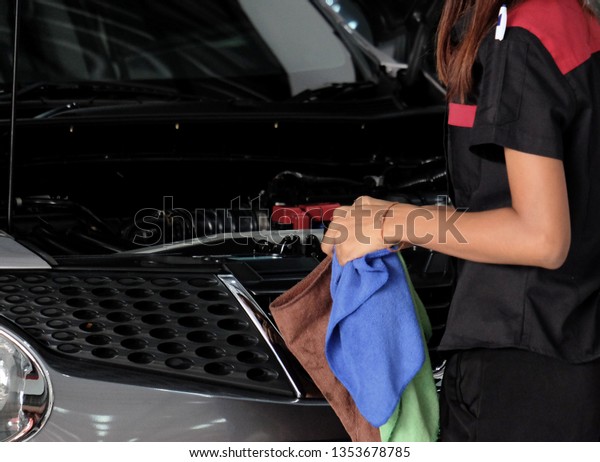 Worker cleaning car with\
clothes
