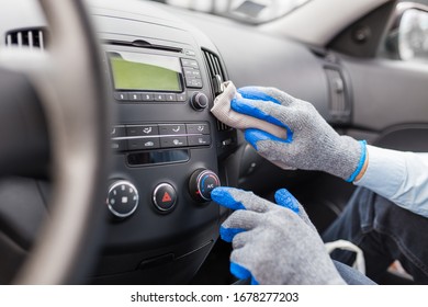 Worker Cleaning Car Interior, Pressing Ac Button And Holding Microfiber Cloth.