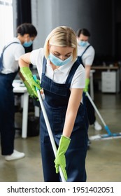 Worker Of Cleaning Company In Medical Mask Holding Mop In Office