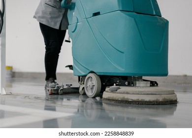 worker is cleaning floor with machine	 - Shutterstock ID 2258848839