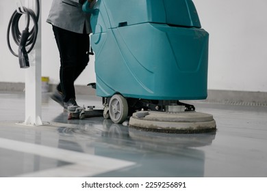 worker is cleaning floor with machine	 - Shutterstock ID 2259256891