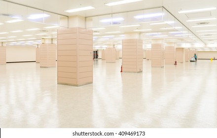 Worker Cleaning Hall Floor Of Office Building