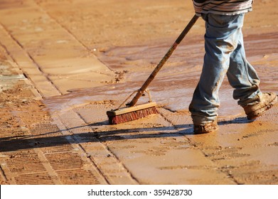 Worker Cleaning The Road In Construction Site